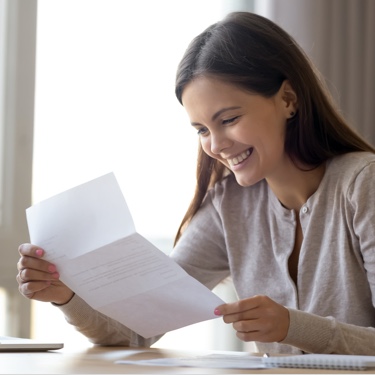Smiling lady reading letter