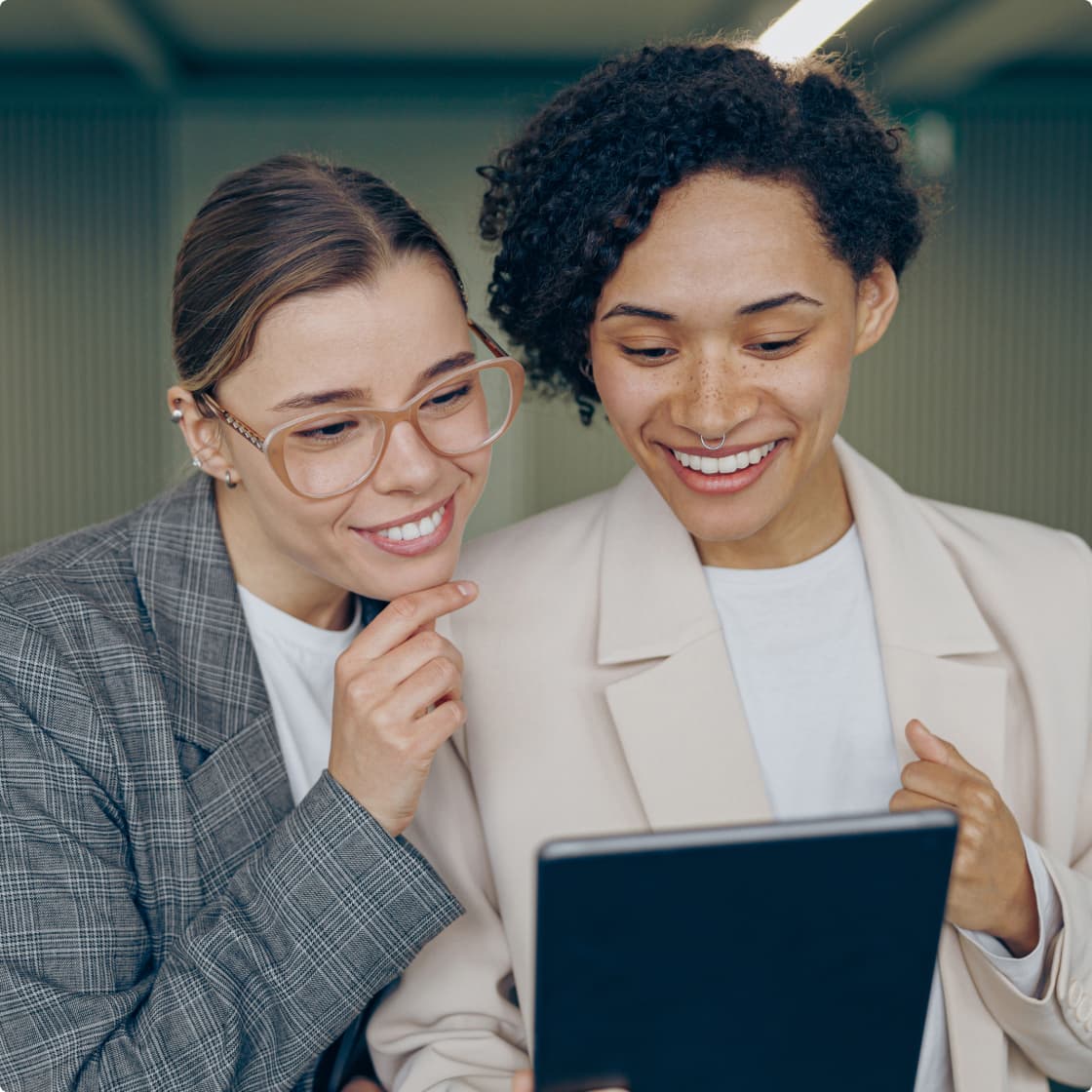 two women looking in tablet