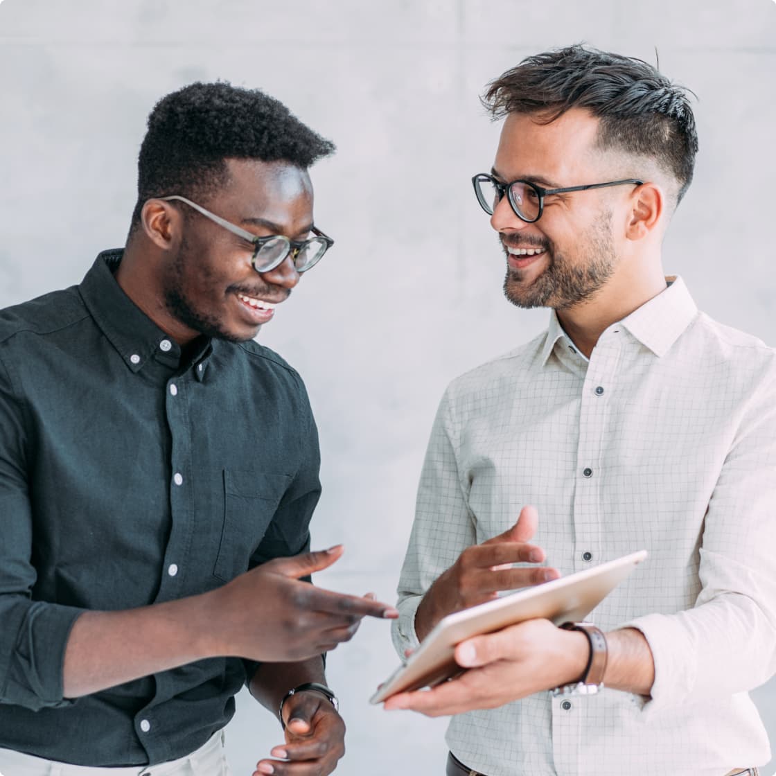 two men looking at a tablet in office