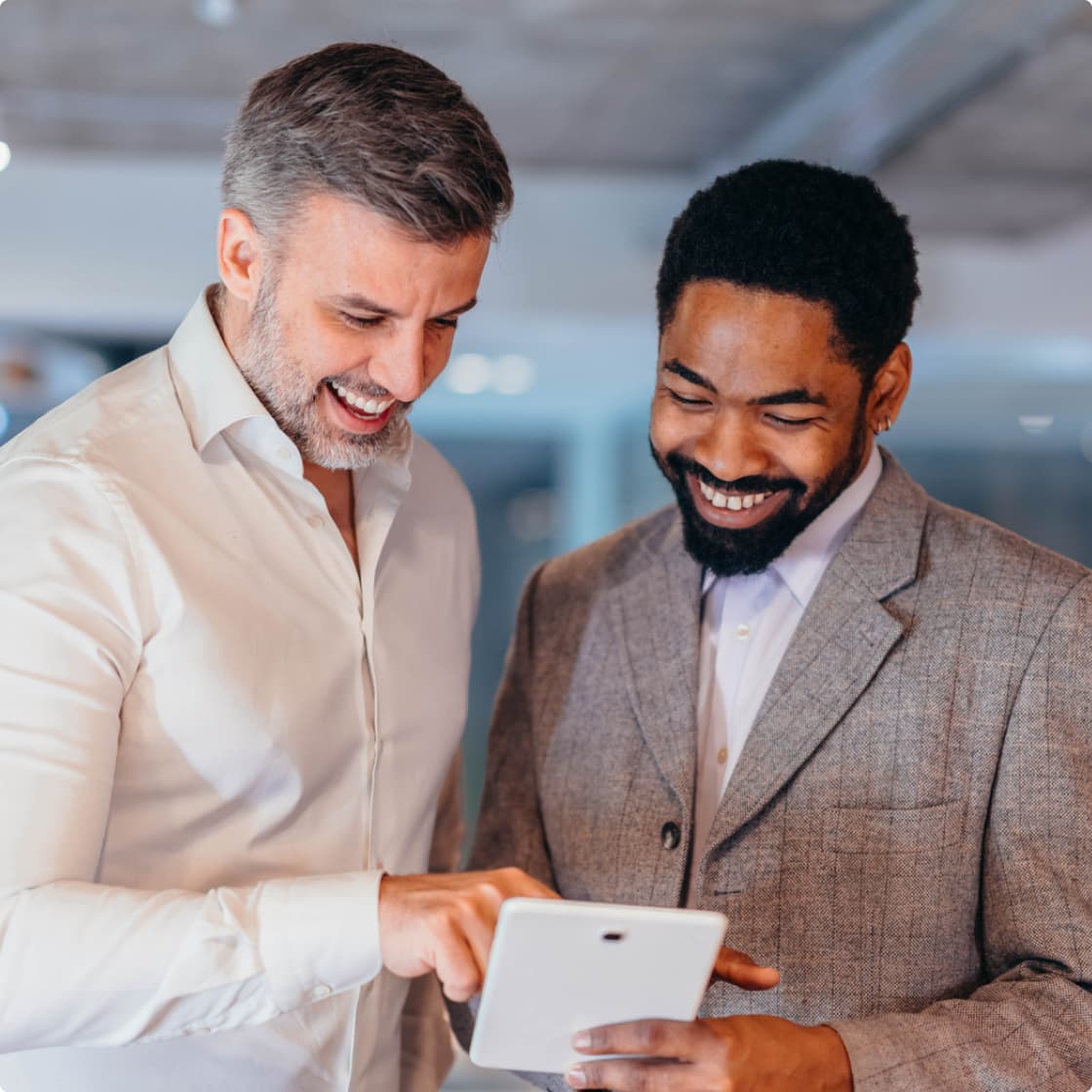 two male workers at office discussing