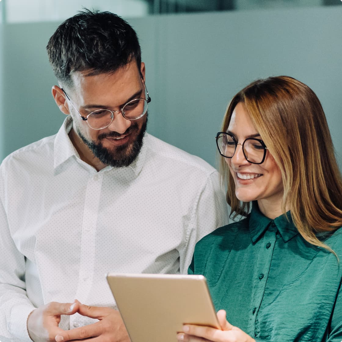 white shirt man and green shirt woman in office