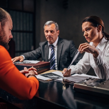 Defense lawyer showing photo to client