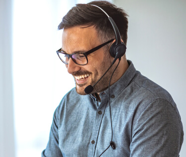 Male receptionist with glasses wearing a headset