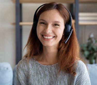 Male receptionist in blue shirt wearing headset