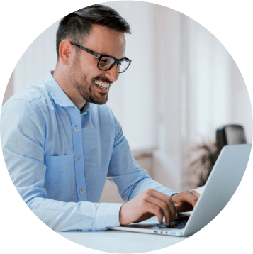 Man in blue shirt using laptop